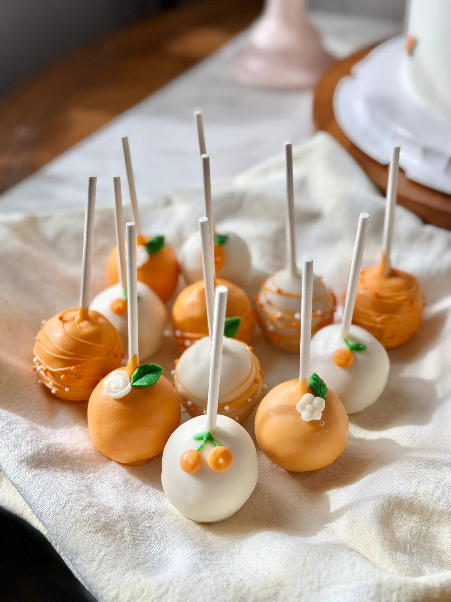 Orange and white cake pops with little fruit details