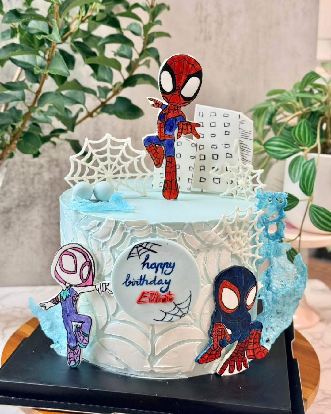 Blue birthday cake with hand-painted Spidey characters