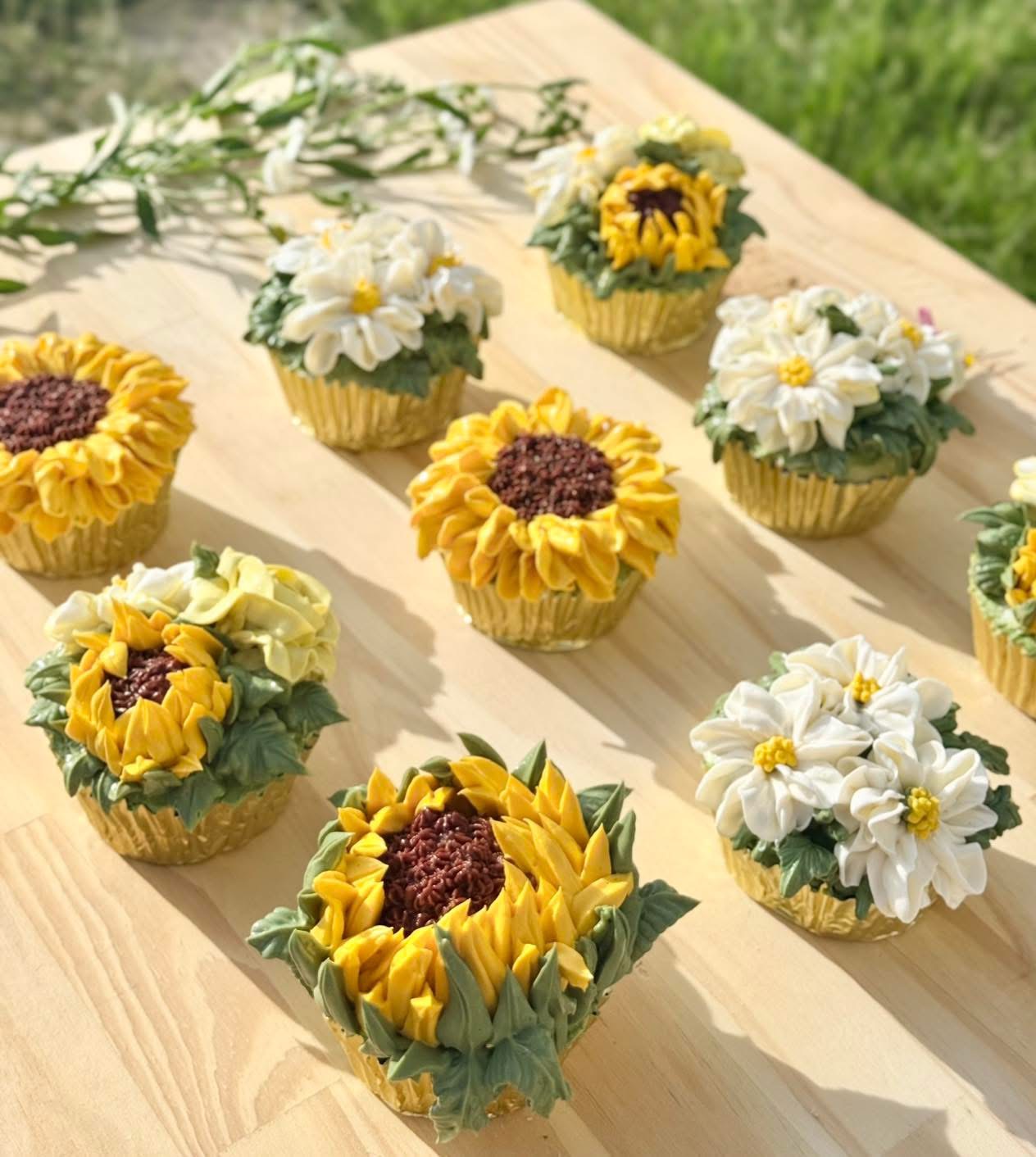 Cupcakes piped to look like sunflowers and daisies